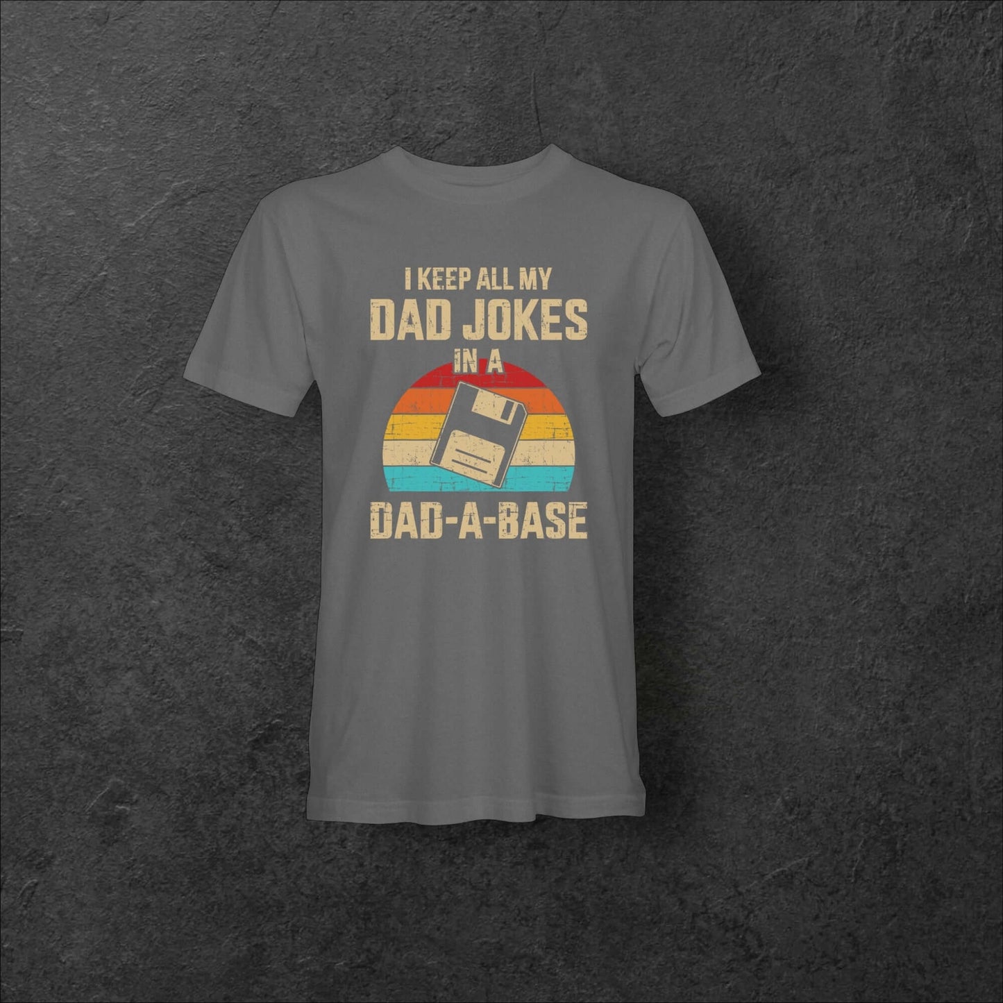 Gray retro Dad-A-Base tee featuring floppy disk design and phrase about storing dad jokes.