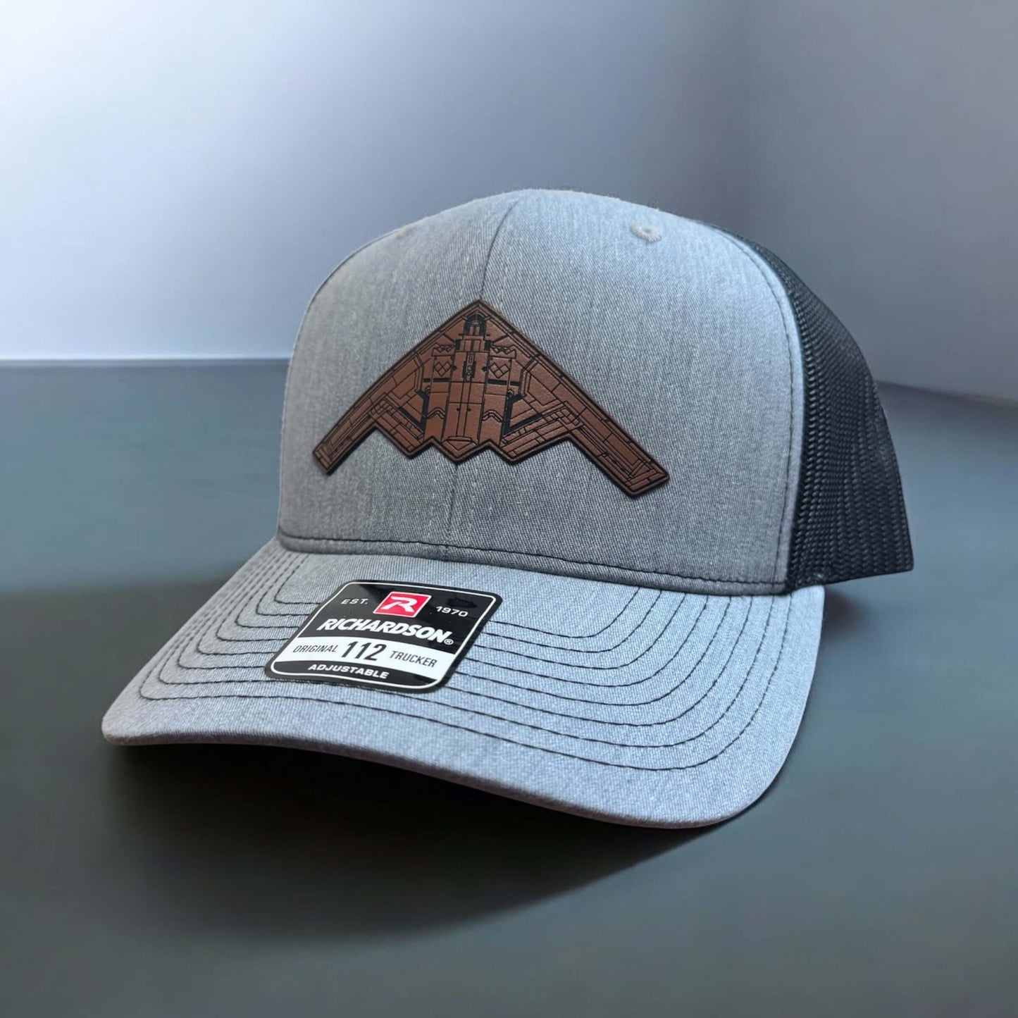 B-2 Bomber Hat with leatherette patch on a gray Richardson 112 trucker cap, symbolizing patriotism and American innovation.