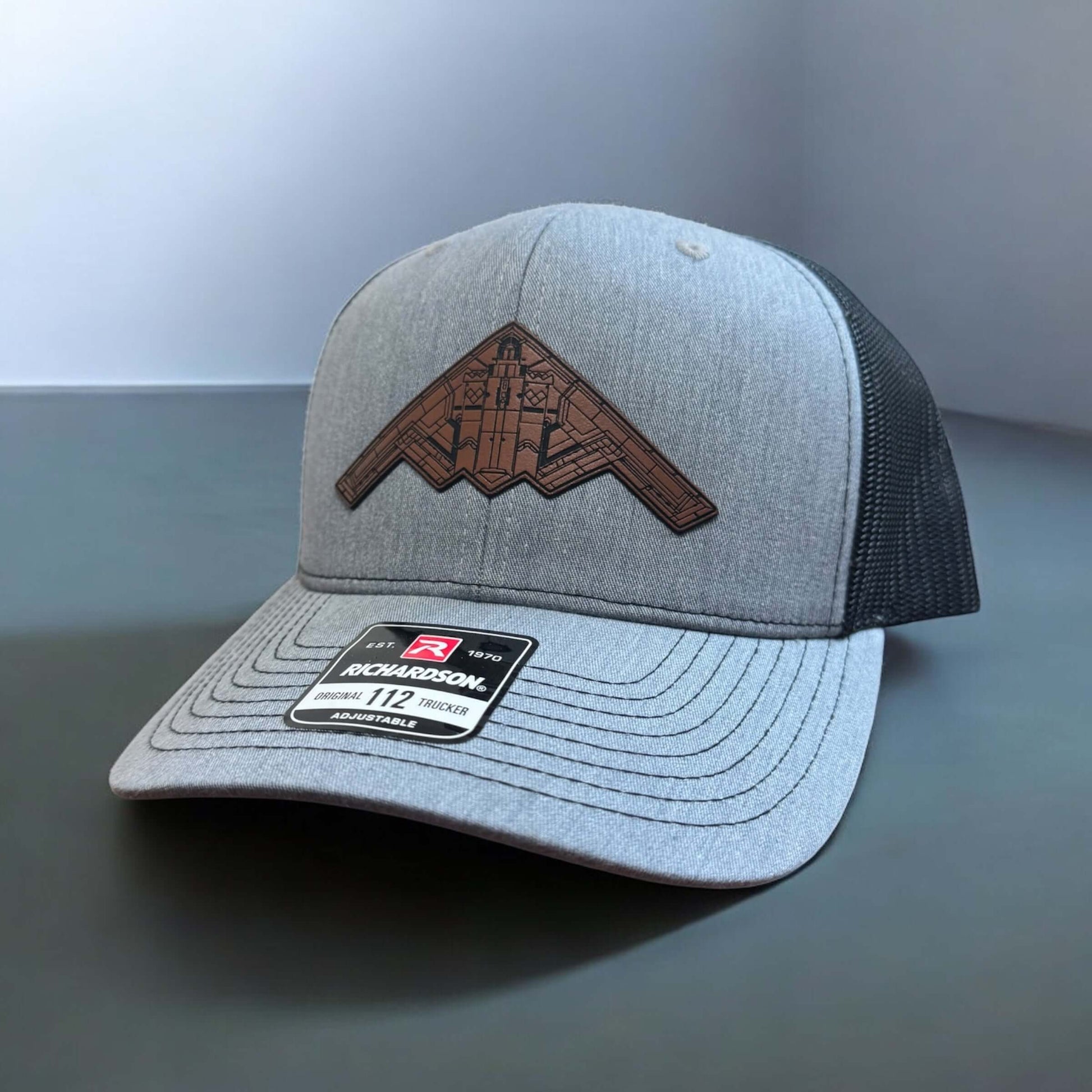B-2 Bomber Hat with leatherette patch on a gray Richardson 112 trucker cap, symbolizing patriotism and American innovation.